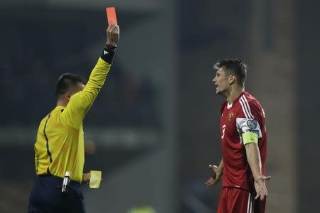 Referee Hueseyin Goecek of Turkey shows a red card to Belarus' Aleksandr Martynovich during their Euro 2016 qualifying soccer match in Zilina, Slovakia, October 9, 2015. REUTERS/David W Cern