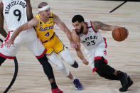 Toronto Raptors' Fred VanVleet (23) drives into Los Angeles Lakers' Alex Caruso (4) during the first half of an NBA basketball game Saturday, Aug. 1, 2020, in Lake Buena Vista, Fla. (AP Photo/Ashley Landis, Pool)