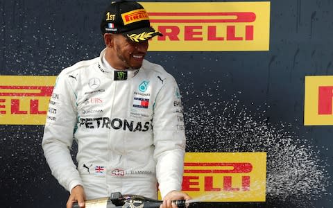 Circuit Paul Ricard, Le Castellet, France - June 24, 2018 Mercedes™ Lewis Hamilton celebrates on the podium after winning the race - Credit: REUTERS