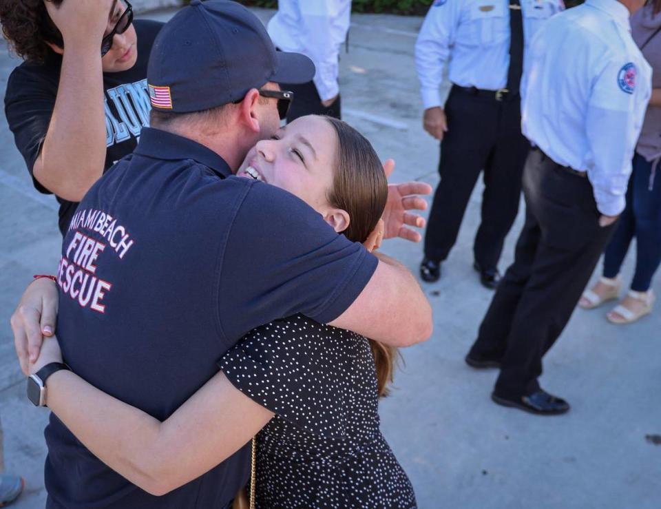 Capt. David Garcia, left, receives a “welcome home” hug from his niece, Sole Diaz, 12, on Sunday. He was among the eight Miami Beach Fire Rescue members who had been deployed to Israel and who were welcomed back by their families, fellow first responders, elected officials, and residents at Miami Beach Fire Station 2. Story, 3A More on the Hamas-Israel war, 8A
