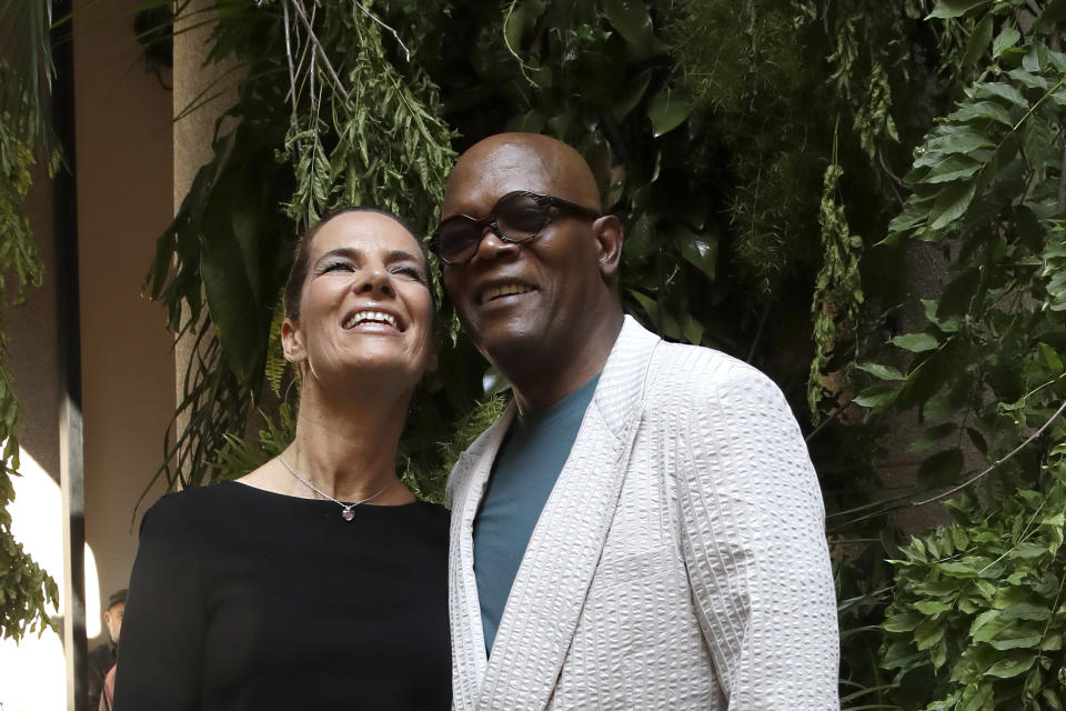 Actors Roberta Armani, left, and Samuel L. Jackson attend the Armani men's Spring-Summer 2020 collection, unveiled during the fashion week, in Milan, Italy, Monday, June 17, 2019. (AP Photo/Luca Bruno)