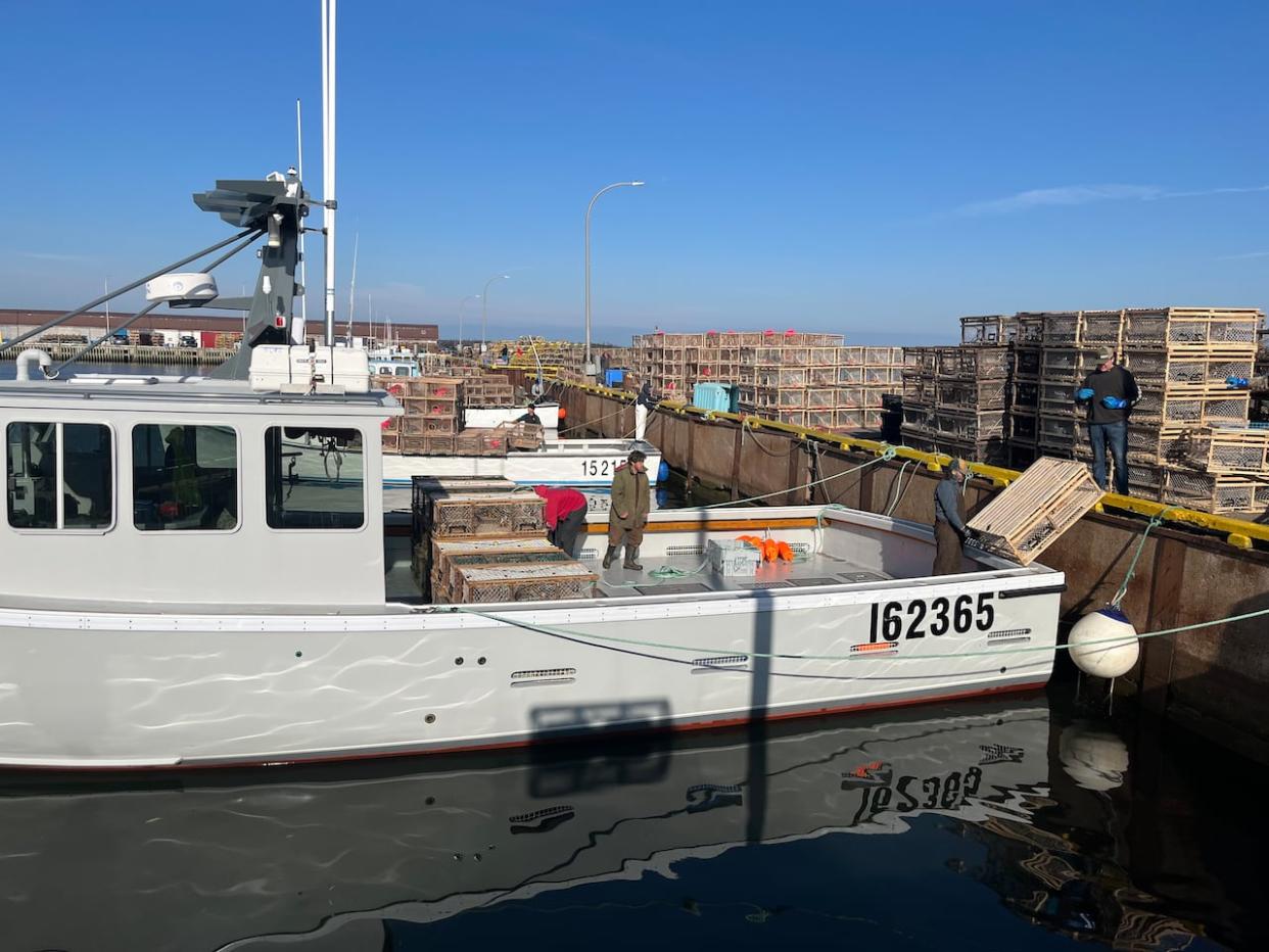 Lobster traps being loaded at Beach Point Wharf on the spring fishery's opening day in April 2023. (Nicola MacLeod/CBC - image credit)