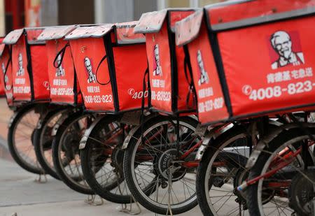 FILE PHOTO -- Logos of KFC, owned by Yum Brands Inc, are seen on its delivery bicycles in front of its restaurant in Beijing February 25, 2013. REUTERS/Kim Kyung-Hoon/File Photo