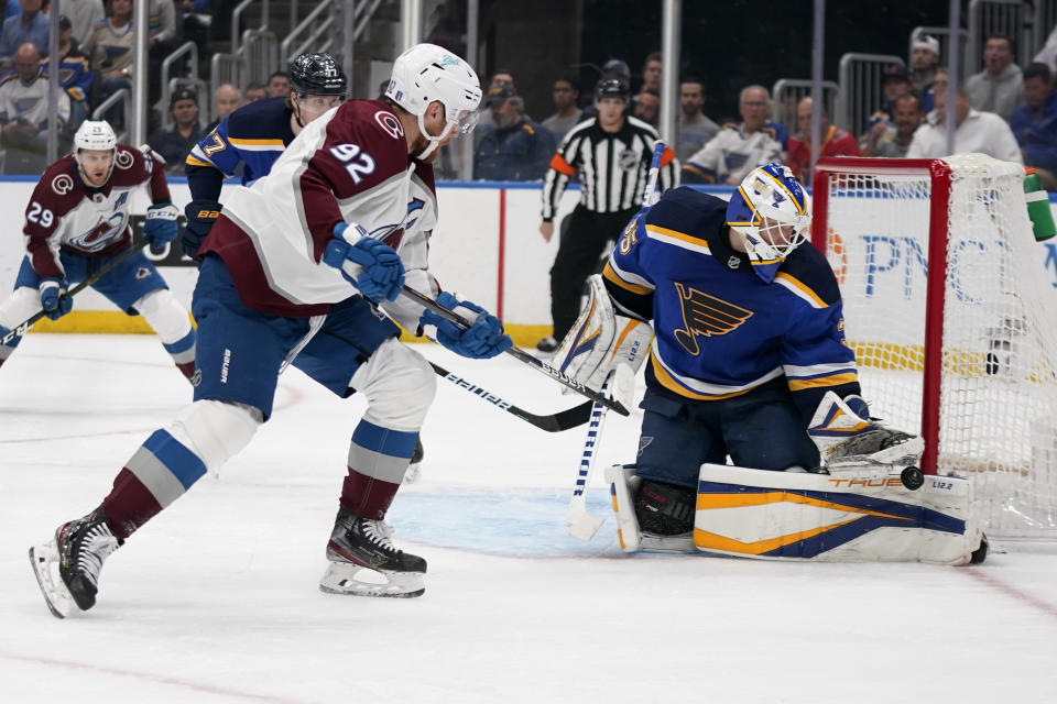 Colorado Avalanche's Gabriel Landeskog (92) shoots wide of St. Louis Blues goaltender Ville Husso (35) during the first period in Game 6 of an NHL hockey Stanley Cup second-round playoff series Friday, May 27, 2022, in St. Louis. (AP Photo/Jeff Roberson)