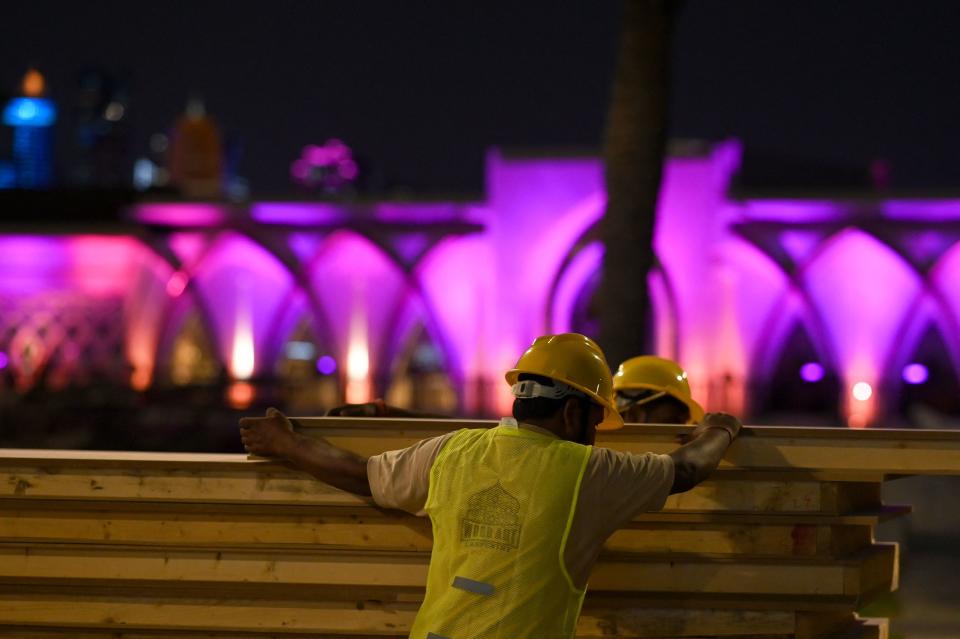 Labourers work to build a structure along a street in Doha. Image: GABRIEL BOUYS/AFP via Getty Images