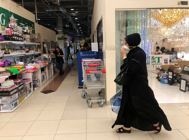 A woman wears a protective face mask, following the outbreak of the new coronavirus, as she walks at Dragon Mart, a Chinese themed discount shopping centre, in Dubai