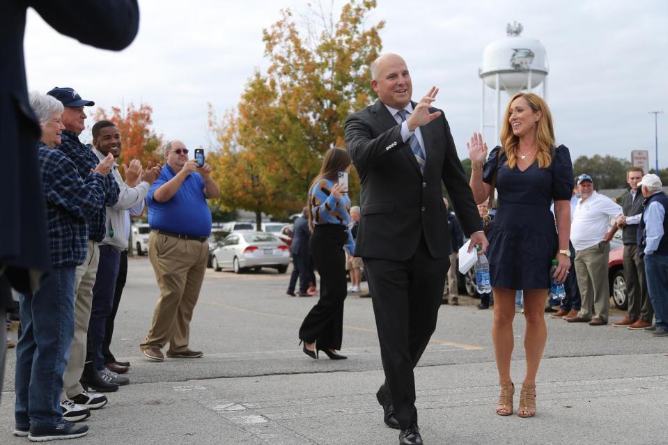 New head football coach Clay Helton and his wife Angela wave to Georgia Southern fans as they participate in their first "Eagle Walk" in November 2021 in Statesboro.