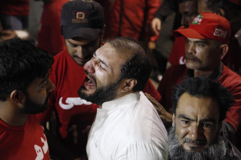 In this Friday, Jan. 17, 2014, photo, a Pakistani man grieves outside a hospital for the death of his brother, a religious cleric who was killed by gunmen in January, in Karachi, Pakistan. 44 police officers were killed in the line of duty during the first two months of the year in Karachi, marking a particularly violent beginning of the year for police. This spike came after the police were already reeling from the killings of 166 officers last year _ roughly one every other day and a four-fold increase from just five years earlier.(AP Photo/Shakil Adil)