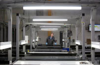 A production operator checks a panel at the SolarWorld solar panel factory in Hillsboro, Oregon, U.S, January 15, 2018. Picture taken January 15, 2018 REUTERS/Natalie Behring