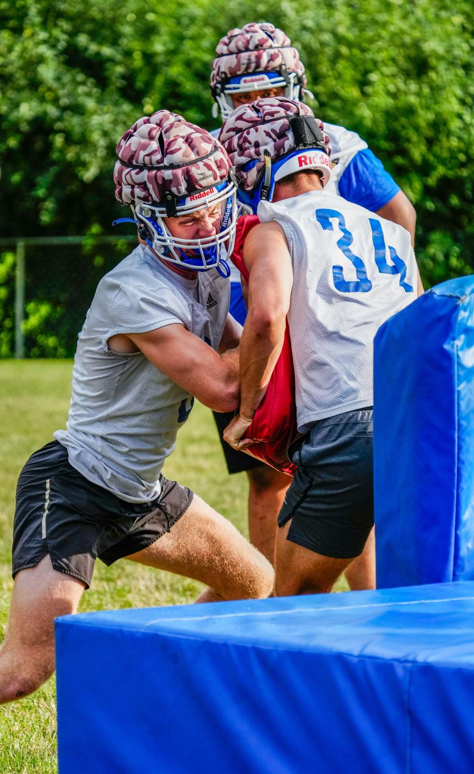 New Berlin West's Jack Wesolowski, left, works with Patrick Bertsch during the first day of high school football practice Tuesday.