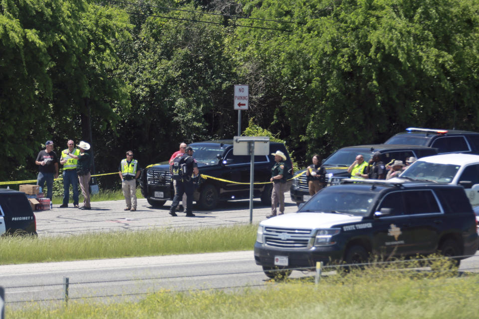 Emergency personnel work at the scene after an 18-wheeler crashed into the Texas Department of Public Safety Office in Brenham, Texas, Friday, April 12, 2024. A suspect is in custody in connection to a commercial vehicle crash at the Texas Department of Public Safety office in the rural town west of Houston. Texas DPS officials say multiple injuries were reported in the crash. (AP Photo/Lekan Oyekanmi)