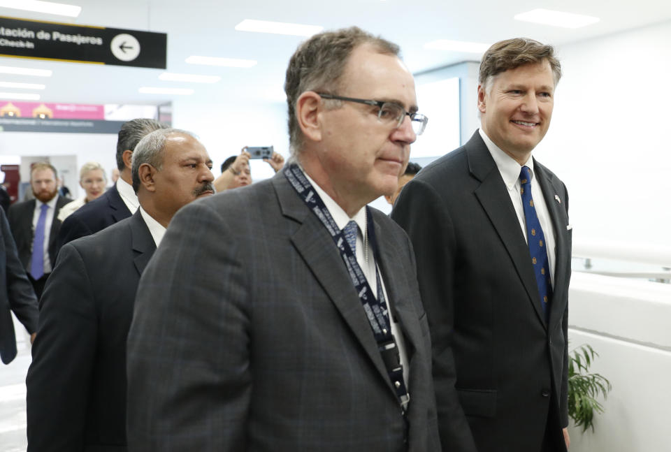 Christopher Landau, the new U.S. ambassador to Mexico, right, walks after delivering a statement to members of the media at the Benito Juarez International Airport, upon his arrival to Mexico City, Friday, Aug. 16, 2019. (AP Photo/Eduardo Verdugo)