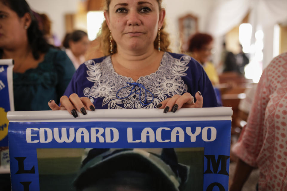 Mothers and relatives of jailed anti-government demonstrators holds signs with images of their imprisoned family, at the San Miguel Arcangel Church in Masaya, Nicaragua, Thursday, Nov. 14, 2019. The group have started a hunger strike to demand the freedom of their relatives, jailed for protesting against the government of President Daniel Ortega. (AP Photo/Alfredo Zuniga)