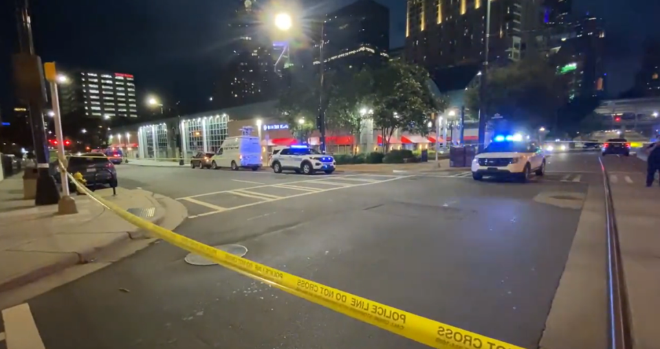 In this screenshot from WSOC video, police surround the Charlotte Transportation Center in uptown after a shooting killed one person and injured another on Friday, June 24, 2022.
