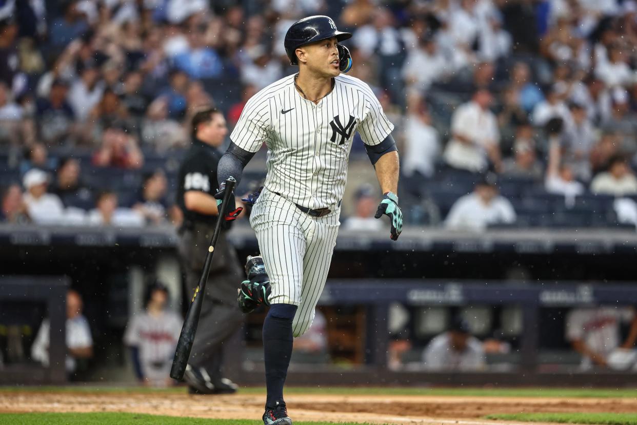 Jun 22, 2024; Bronx, New York, USA; New York Yankees designated hitter Giancarlo Stanton (27) hits a double against the Atlanta Braves in the fourth inning at Yankee Stadium. Mandatory Credit: Wendell Cruz-USA TODAY Sports