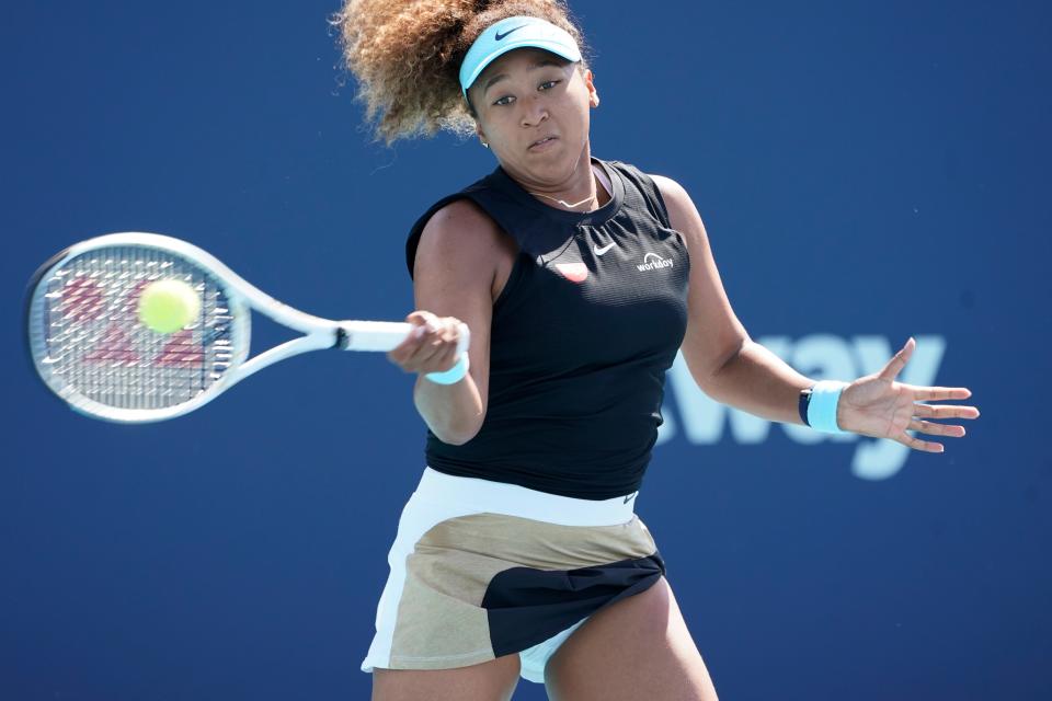 Naomi Osaka, of Japan, returns to Elise Mertens, of Belgium, during the Miami Open tennis tournament, Monday, March 29, 2021, in Miami Gardens, Fla. (AP Photo/Marta Lavandier)