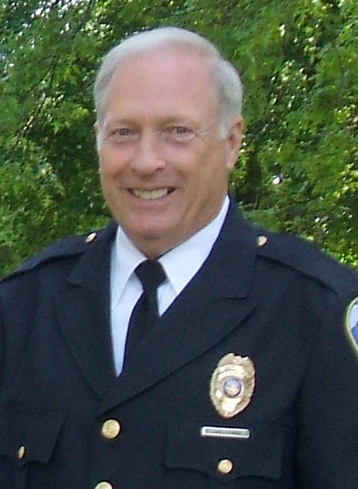 Akron Police Sgt. Tom Dye takes a portrait before his retirement in 2010.