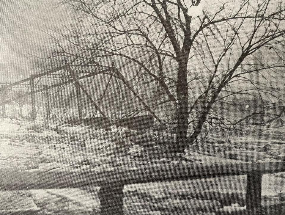 The old bridge is swept away in 1910.