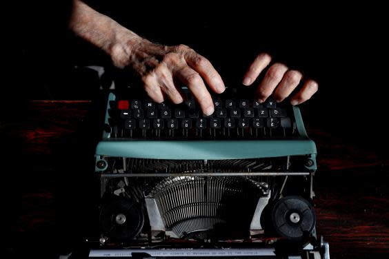 Paterno at his typewriter on the day before graduation (Reuters/Guglielmo Mangiapane)