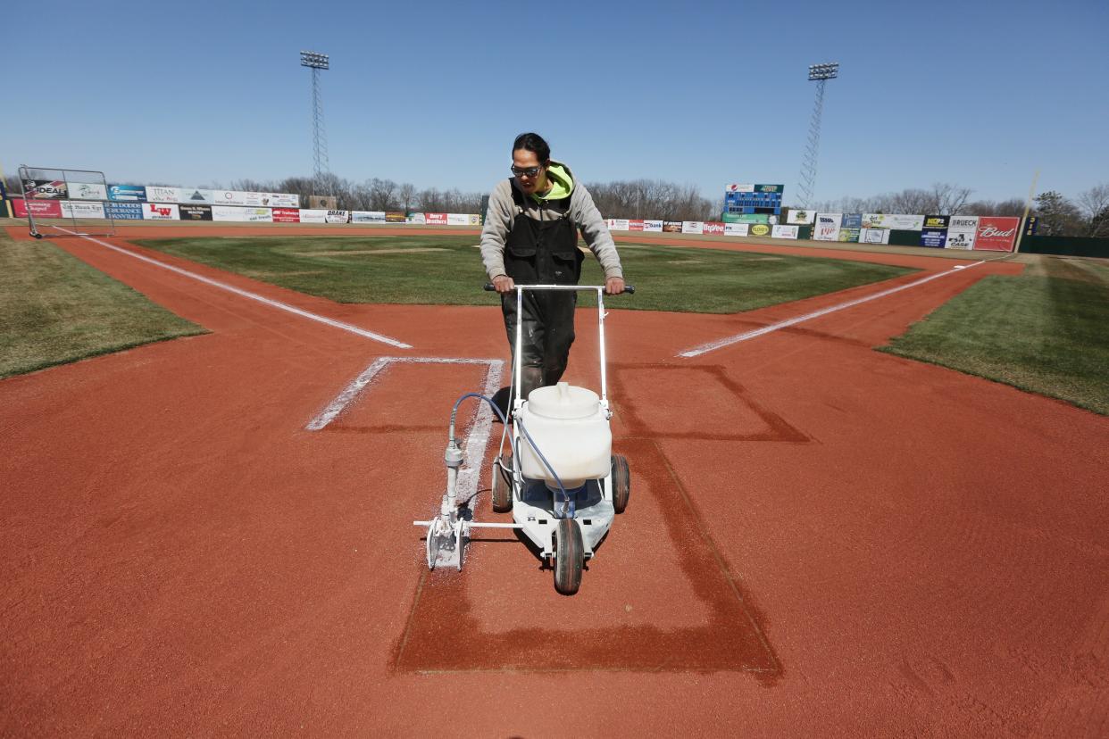 Brian Benally, a member of the Burlington Bees grounds crew and maintenance department prepares the field for practice on April 4, 2018 at Community Field. [John Lovretta/thehawkeye.com]