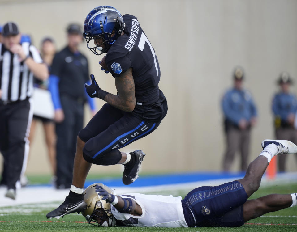 Air Force wide receiver David Cormier, left, is tripped up by Navy cornerback Mbiti Williams Jr. after catching a pass in the first half of an NCAA college football game Saturday, Oct. 1, 2022, at Air Force Academy, Colo. (AP Photo/David Zalubowski)