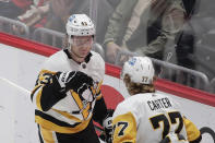 Pittsburgh Penguins' Danton Heinen, left, celebrates with teammate Jeff Carter (77) after scoring during the first period of an NHL hockey game against the Washington Capitals, Friday, Dec. 10, 2021, in Washington. (AP Photo/Luis M. Alvarez)