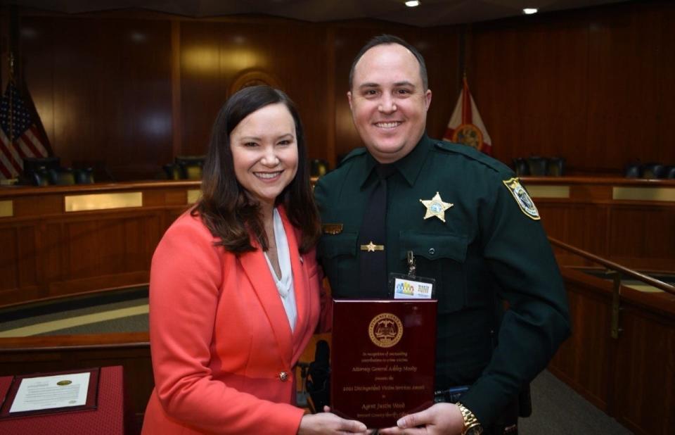 Florida Attorney General Ashley Moody, with Brevard County Sheriff's Office Agent Justin Wood