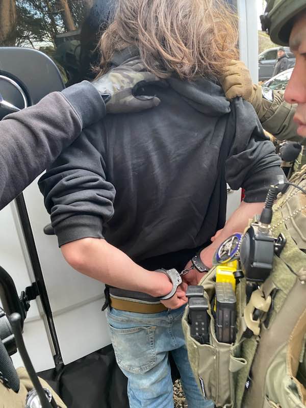 Authorities arrest Miles Pfeffer, 18, of Buckingham, at his Quarry Road home on Sunday, Feb. 19, 2023, using handcuffs belonging to Temple University Police Officer Chris Fitzgerald, who was killed Saturday.