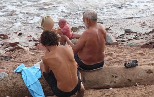 A young child, presumably the newborn's older sibling, gets to meet the baby. Photo: Facebook/Hadia Hosny El Said