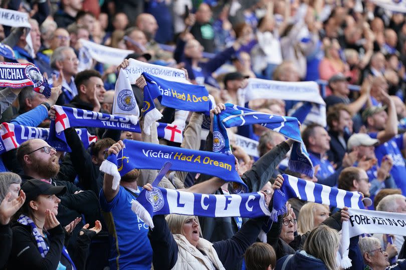 Leicester City fans hold up scarves in tribute to late chairman Vichai Srivaddhanaprabha at the King Power Stadium