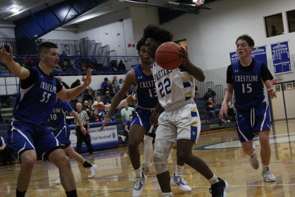 Crestline players Jake Bruce (55), Isaiah Perry (13) and Kieran Barnett (15) trap St. Peters guard Feree Kent during the Bulldogs 49-40 win on Friday night.