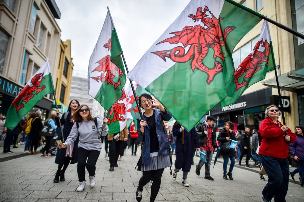People take part in a St David’s Day parade in Cardiff (Ben Birchall/PA) (PA Archive)