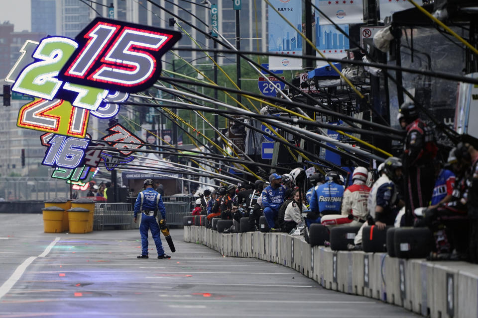 A crew member dries off the pavement in pit row during a NASCAR Cup Series auto race at the Grant Park 220, Sunday, July 2, 2023, in Chicago. (AP Photo/Erin Hooley)