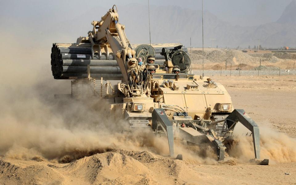 A Trojan vehicle belonging to 5 Armoured Engineer Squadron, cuts through the Helmand dust. - Rupert Frere RLC/Crown Copyright