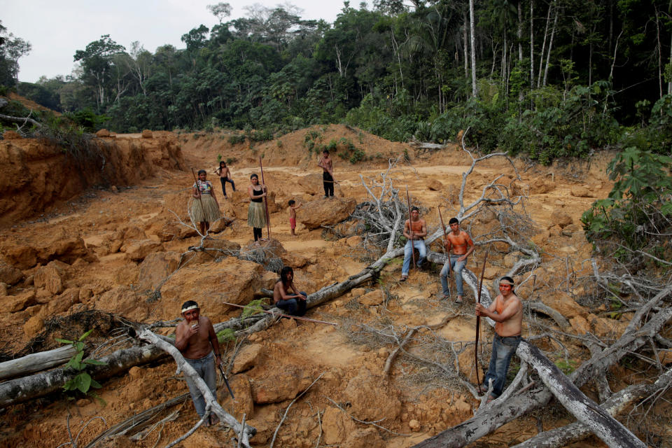 People from the Mura tribe show a deforested area in unmarked indigenous lands inside the Amazon rainforest near Humaita, Amazonas State, Brazil.
