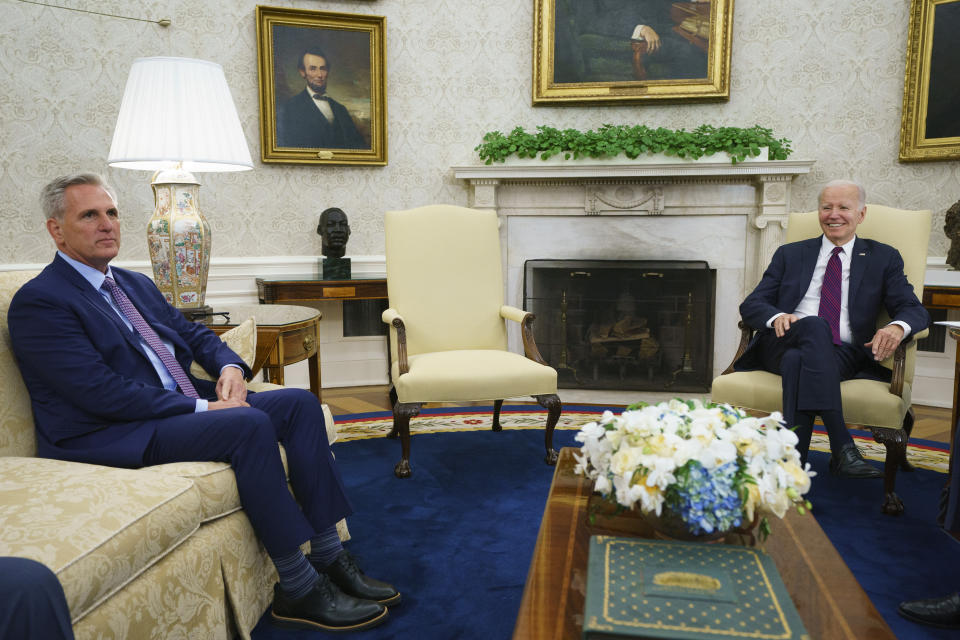 FILE - Speaker of the House Kevin McCarthy of Calif., left, listens as President Joe Biden speaks before a meeting on the debt limit in the Oval Office of the White House, Tuesday, May 9, 2023, in Washington. One outcome is becoming clear as Biden and congressional leaders reach for a budget deal to end the debt ceiling standoff: The COVID-era big government spending, to halt the pandemic and rebuild in its aftermath, is giving way to a new fiscal focus on longer term investments and stemming deficits. (AP Photo/Evan Vucci, File)