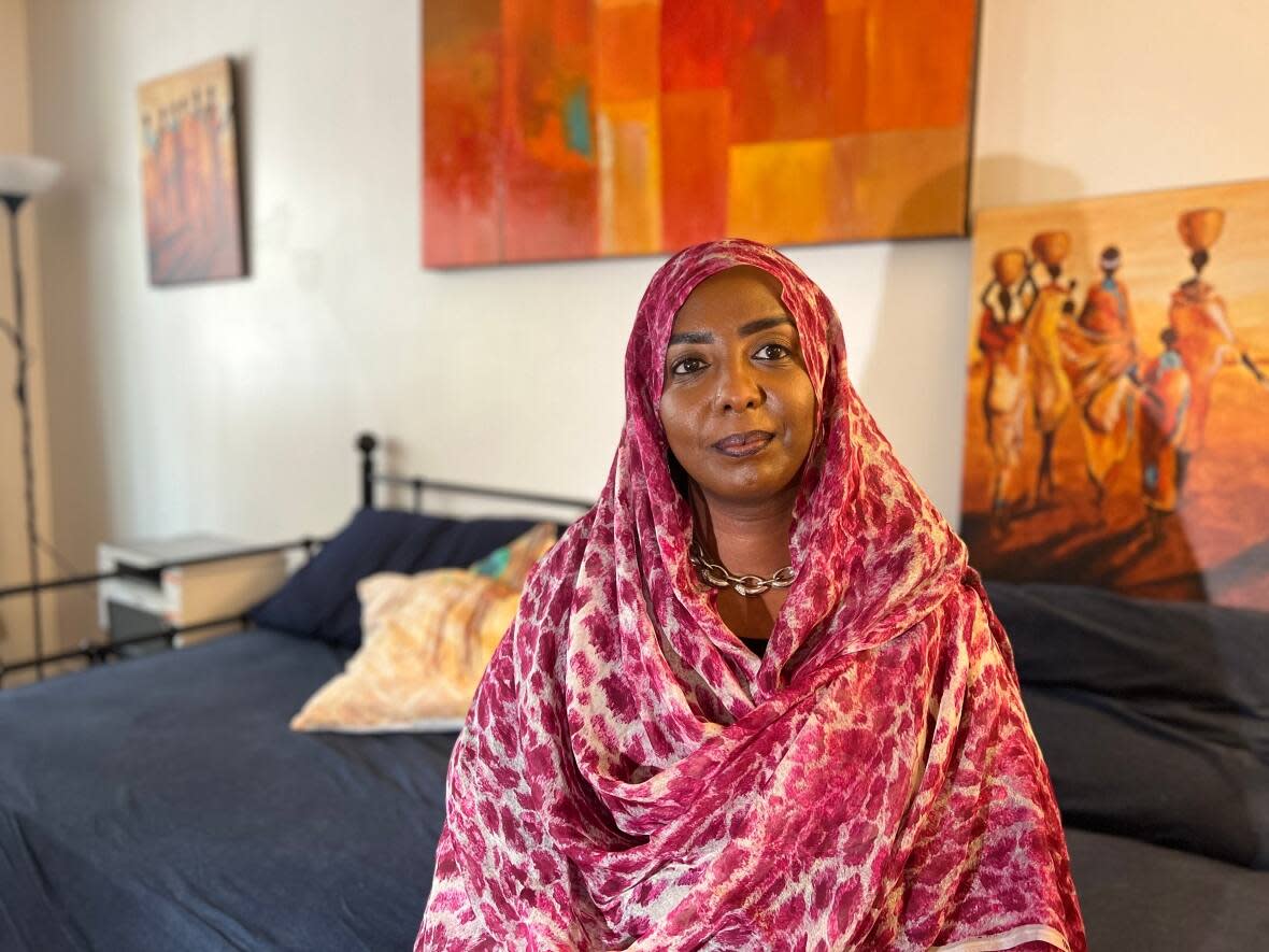Iman Bahaeldin Ahmed is worried about her sister and brother back home in Sudan. While her sister managed to flee to a neighbouring state, Bahaeldin Ahmed hasn't been able to connect with her brother due to interruptions in power and phone connections caused by the bombings.  (Chloë Ranaldi/CBC - image credit)