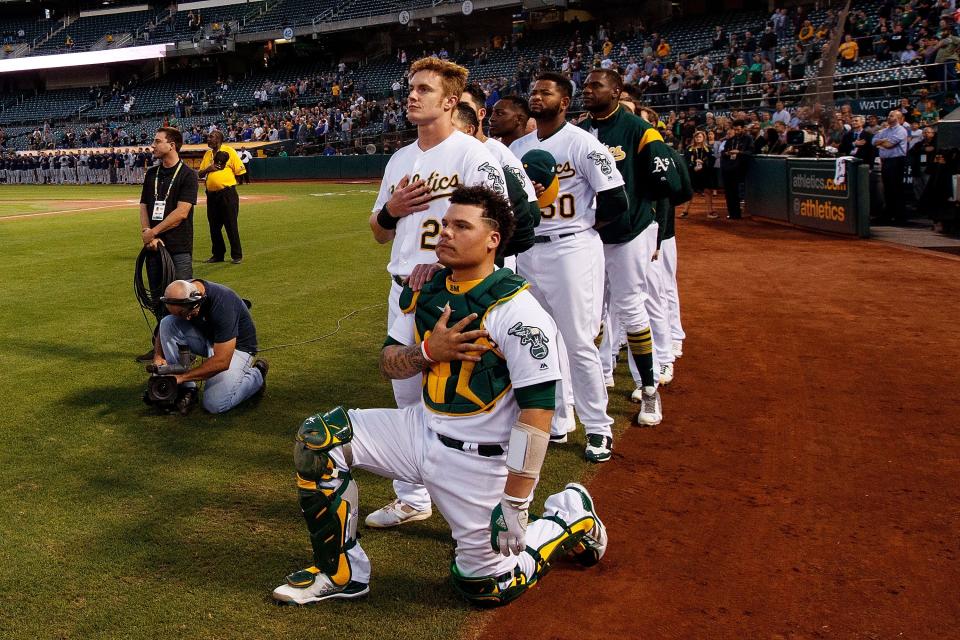 Athletics catcher Bruce Maxwell was cheered by fans after taking a knee during the national anthem. (Photo by Jason O. Watson/Getty Images)