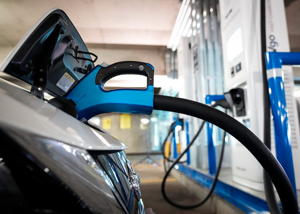 Cropped view of electric vehicle at charging station.