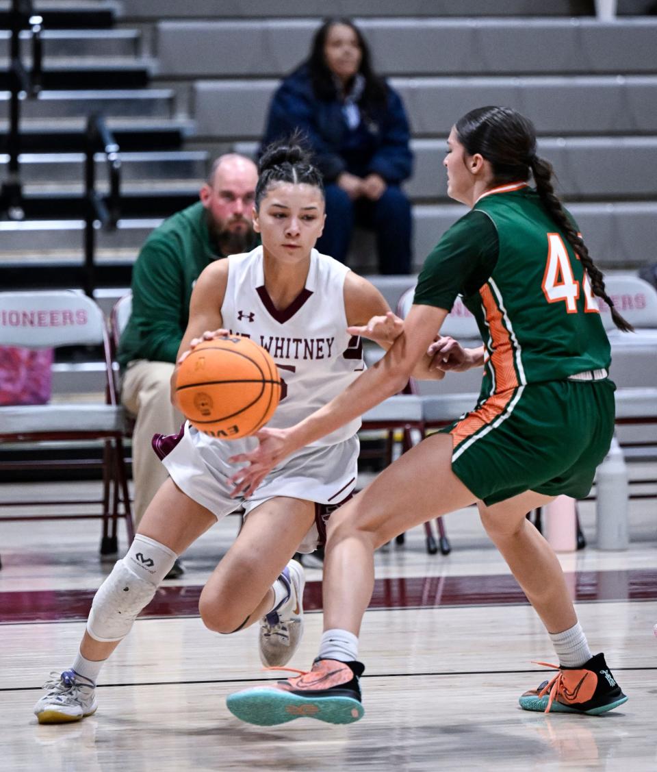 Mt. Whitney's Rashelle Versteeg drives to the basket against Porterville's Ryleigh Schoonover in an East Yosemite League high school girls basketball game Tuesday, January 9, 2024.