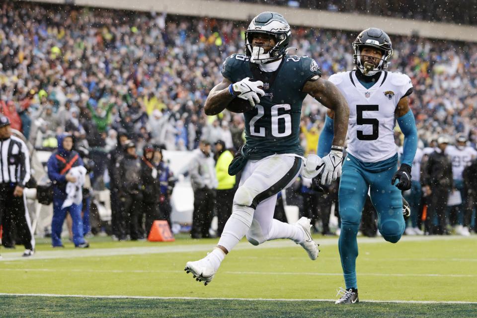 Philadelphia Eagles running back Miles Sanders (26) scores a touchdown on a run as Jacksonville Jaguars safety Andre Cisco (5) chases during the second quarter of an NFL football game, Sunday, Oct. 2, 2022, in Philadelphia. (AP Photo/Rich Schultz)