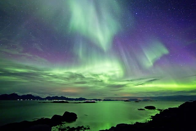 Looking west from the Vesteralen archipelago, and toward the more famous Lofoten islands.The whole sky is covered in a green and