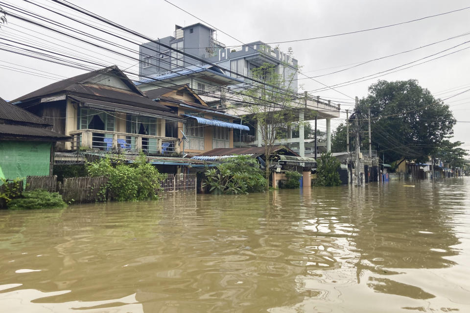 Half-submerged houses are seen on a flooded road in Bago, about 80 kilometers (50 miles) northeast of Yangon, Myanmar, Monday, Oct. 9, 2023. Flooding triggered by heavy monsoon rains in Myanmar’s southern areas has displaced more than 10,000 people and disrupted traffic on the rail lines that connect the country’s biggest cities, officials and state-run media said Monday. (AP Photo/Thein Zaw)