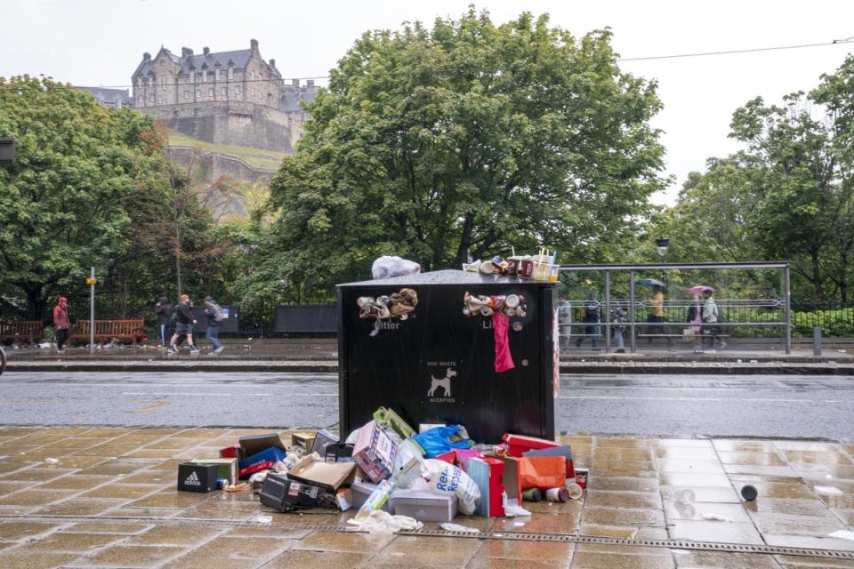 Bins overflowing with litter along Princes Street in Edinburgh city centre (Jane Barlow/PA) (PA Wire)