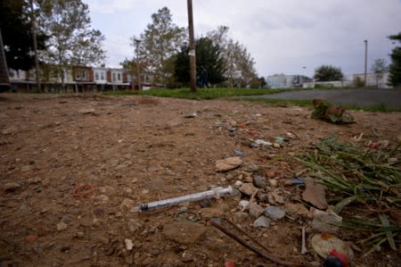 FILE PHOTO: Needle used for shooting heroin litters the ground in a park in the Kensington section of Philadelphia