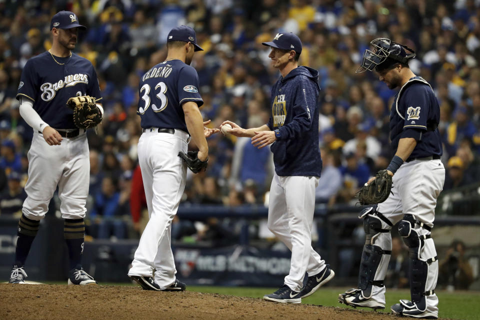 Milwaukee Brewers manager Craig Counsell removes relief pitcher Xavier Cedeno (33) during the ninth inning of Game 2 of the National League Championship Series baseball game against the Los Angeles Dodgers Saturday, Oct. 13, 2018, in Milwaukee. (AP Photo/Jeff Roberson)