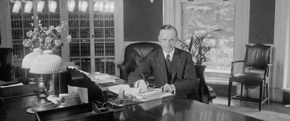 President Calvin Coolidge at the same desk used by Harding in the Oval Office.