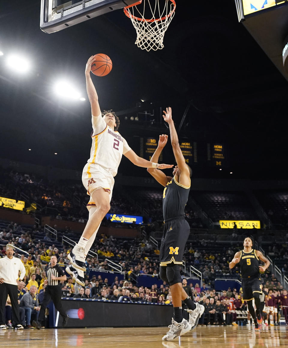 Minnesota guard Mike Mitchell Jr. (2) makes a layup as Michigan guard Nimari Burnett defends during the first half of an NCAA college basketball game, Thursday, Jan. 4, 2024, in Ann Arbor, Mich. (AP Photo/Carlos Osorio)