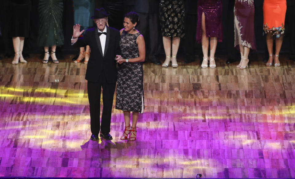 99-year-old James McManus and his dance partner Lucia Seva, stand on stage to be recognized during the finals of the Salon category at the annual Tango Dance World Championship in Buenos Aires, Argentina, Tuesday, Aug. 20, 2019. It’s a dream come true for the Scotland-born tango aficionado. He had not even flown on a plane in more than two decades. But just a few months before his 100th birthday, his friends gave him a plane ticket to the birthplace of tango. He took another step and decided to apply for the annual competition. (AP Photo/Natacha Pisarenko)