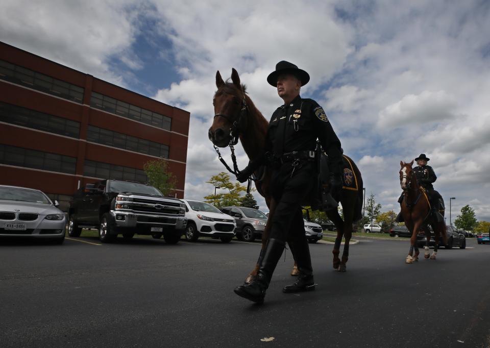 Members of the Erie County Sheriff's Mounted Patrol join family, friends and law enforcement from across the state arrive for the funeral services for Aaron W. Salter Jr. at the Chapel at Cross Point Wednesday, May 25, 2022 in Getzville. Salter was killed during a mass shooting at a Buffalo area Tops grocery a week ago.